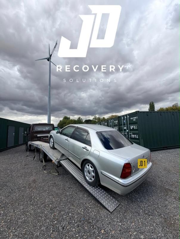 Silver saloon being loaded up the ramp