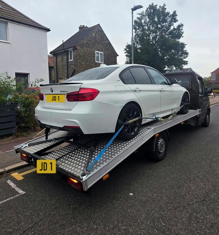 BMW 3 Series recovered on the truck, rear view
