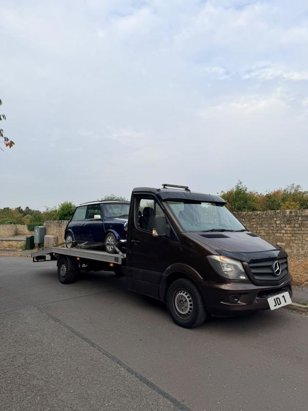 JD Mercedes Sprinter recovery truck carrying a classic Mini
