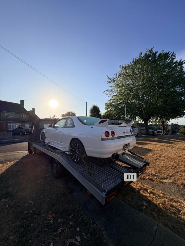 Nissan Skyline on the recovery truck at sunset