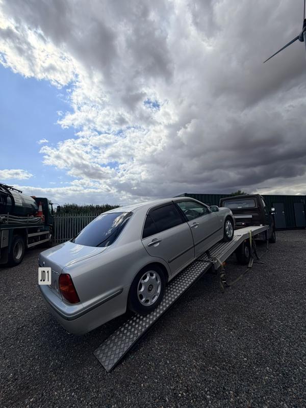 Silver saloon being loaded onto the recovery truck